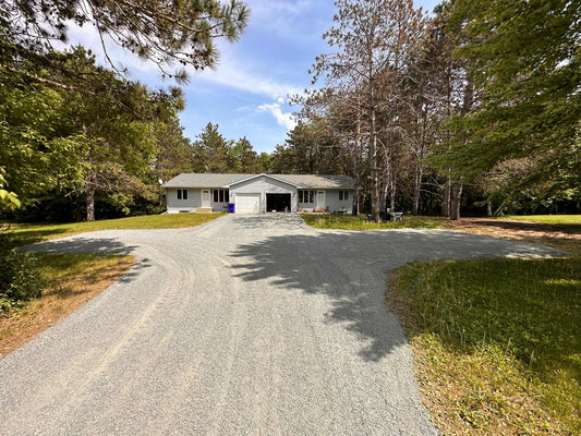 gray gravel driveway with house